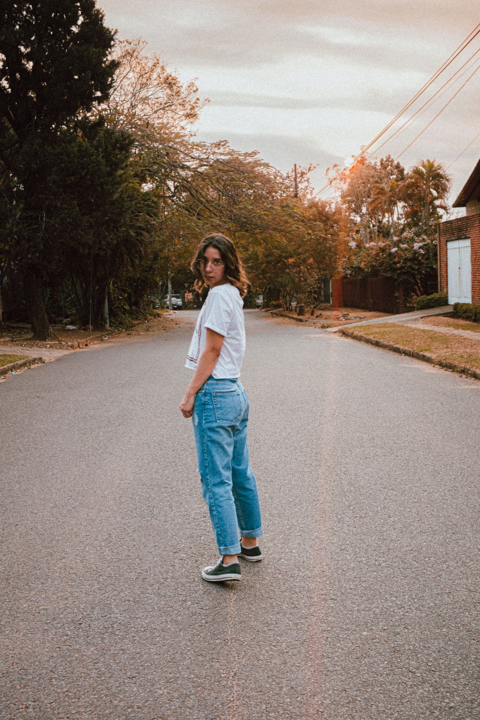 Woman wearing jeans on a residential street