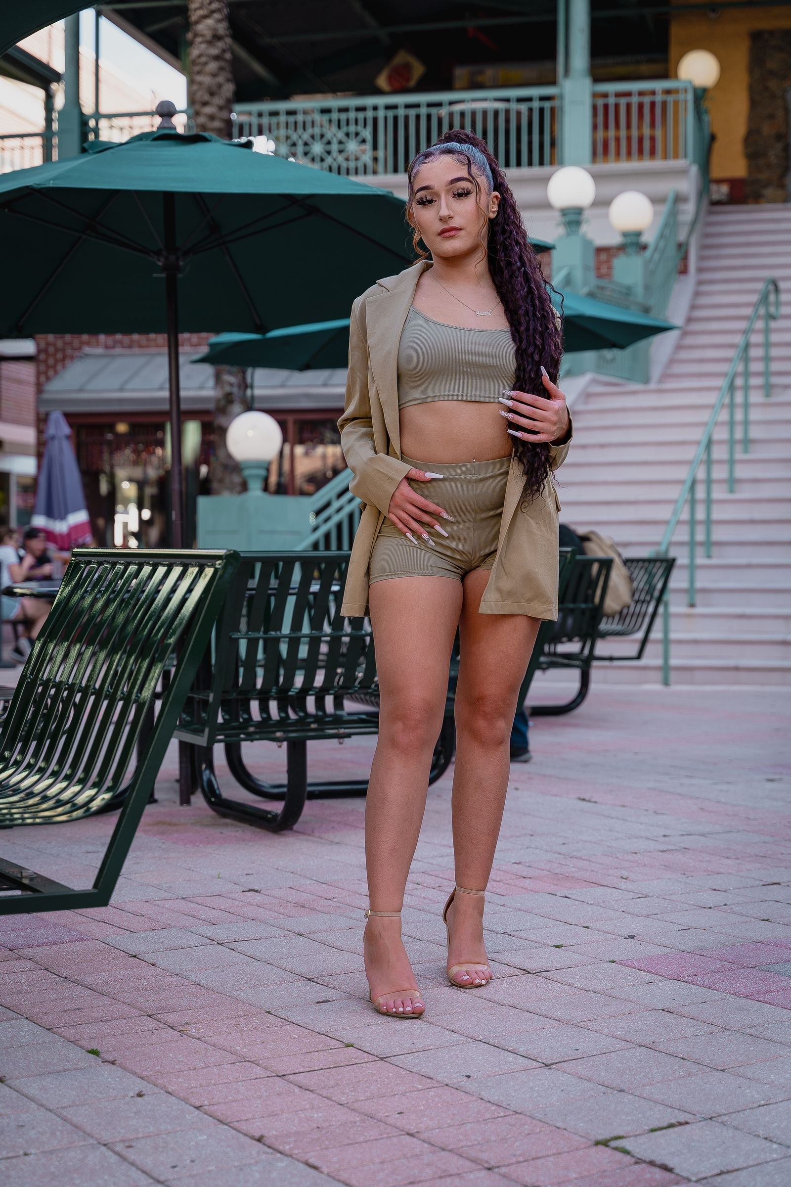 Woman wearing a beige blazer and matching shorts on a city street
