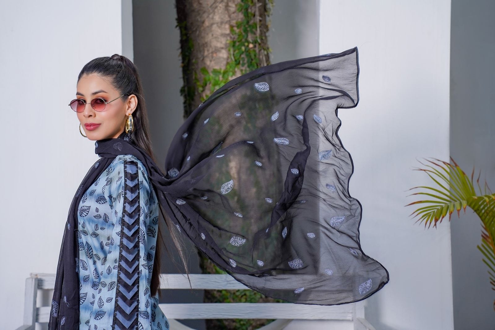 Woman wearing a flowing black scarf outdoors
