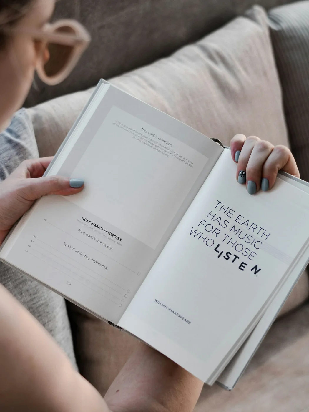 An open book held in a person’s hands.