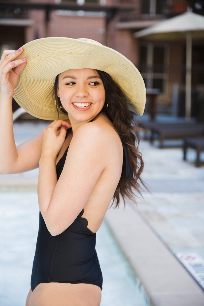 floppy hat and black scallop swimsuit