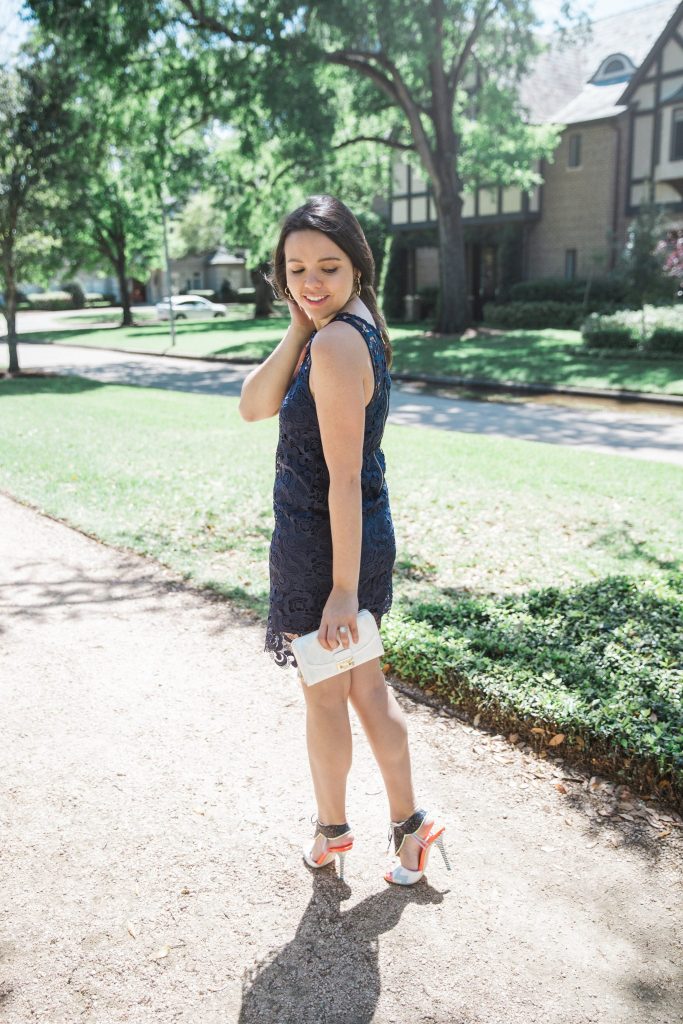 navy dress and white clutch