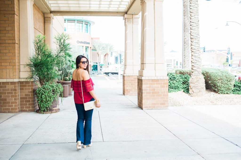 Off the shoulder top with flared jeans and platform sandals