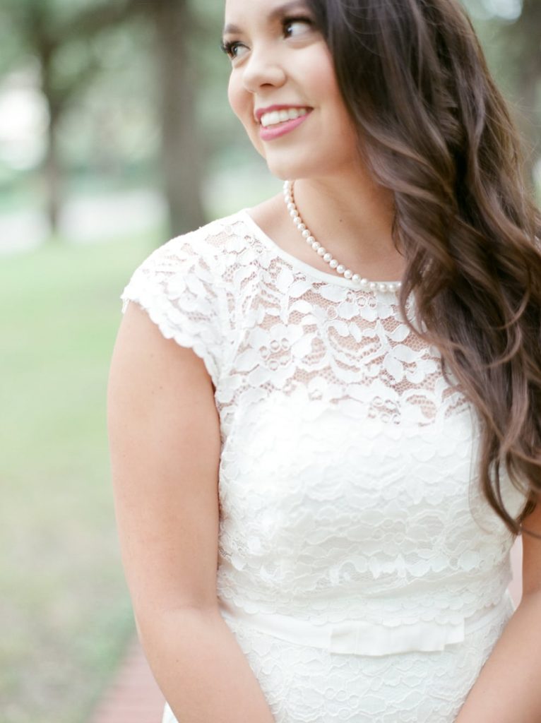 A chic strand of pearls over a white lace dress - such a timeless look! 