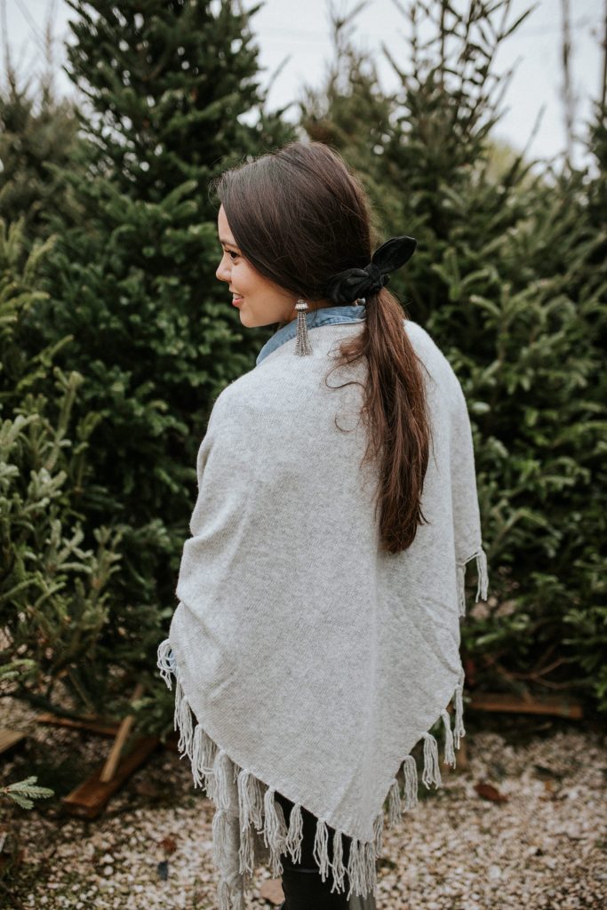 Accent a grey fringe wrap with velvet and tassel accessories