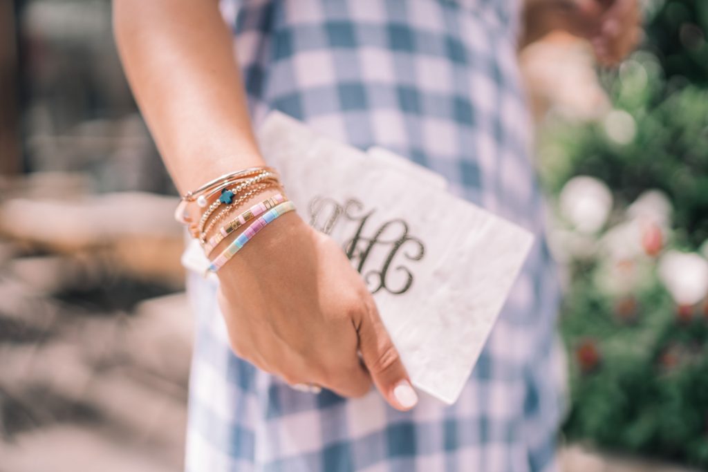 Monogram acrylic clutch, beaded bracelet stack