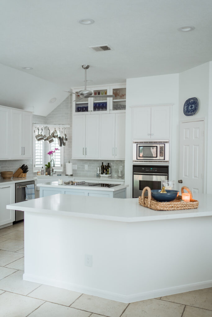 Open plan kitchen remodel with white quartz countertops and Sherwin Williams Snowbound paint | Girl Wonder Life