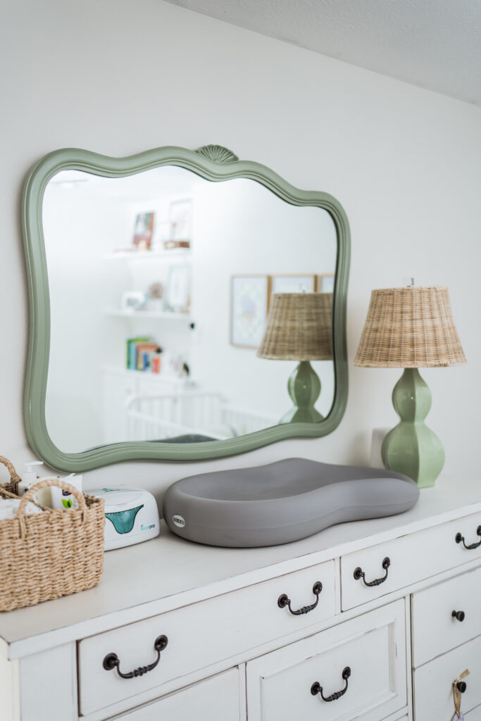 serene baby girl nursery and changing table with pops of green | Girl Wonder Life